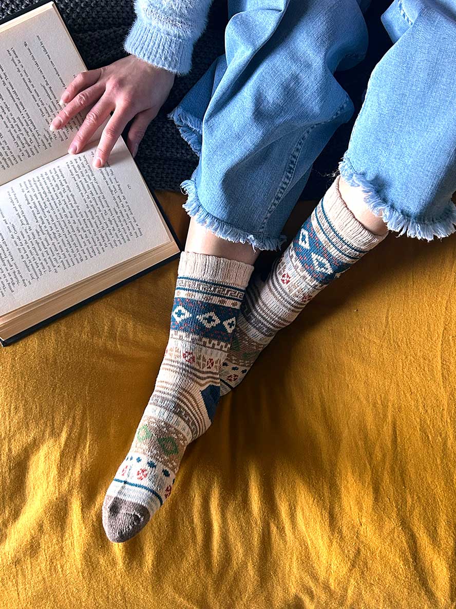 Nordic Style Socks in Bone on bed with book