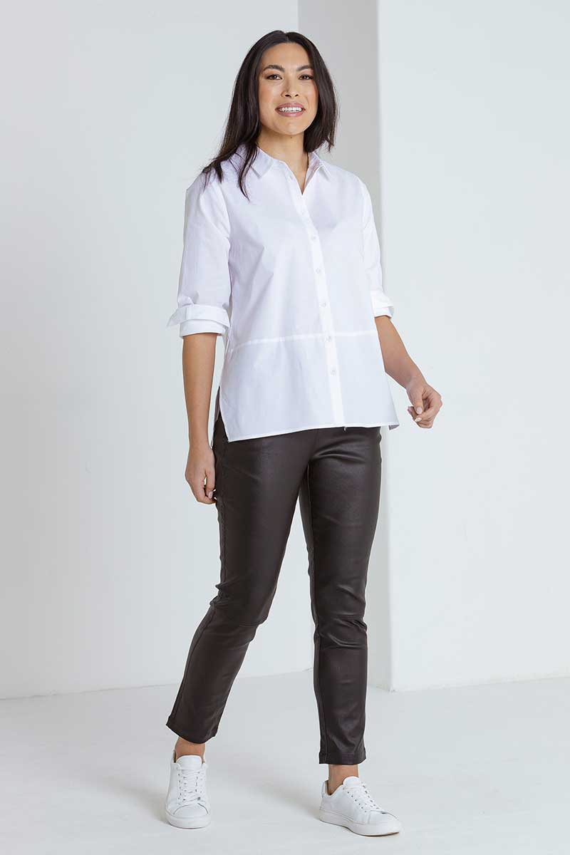 model wearing black pants with the Marco Polo Women's Button Shirt in White