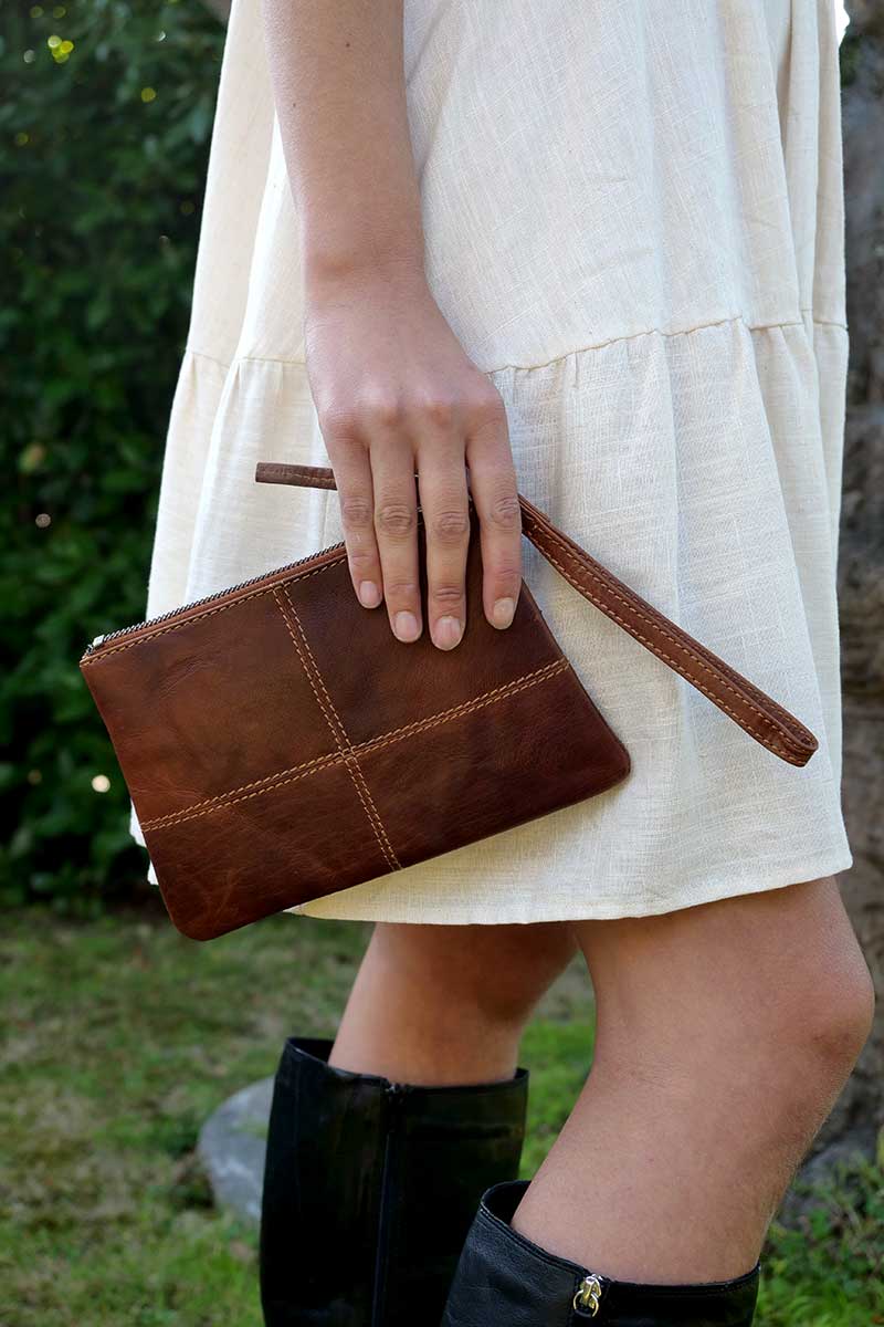 model holding Rugged Hide Leather Clutch - Mia Cognac