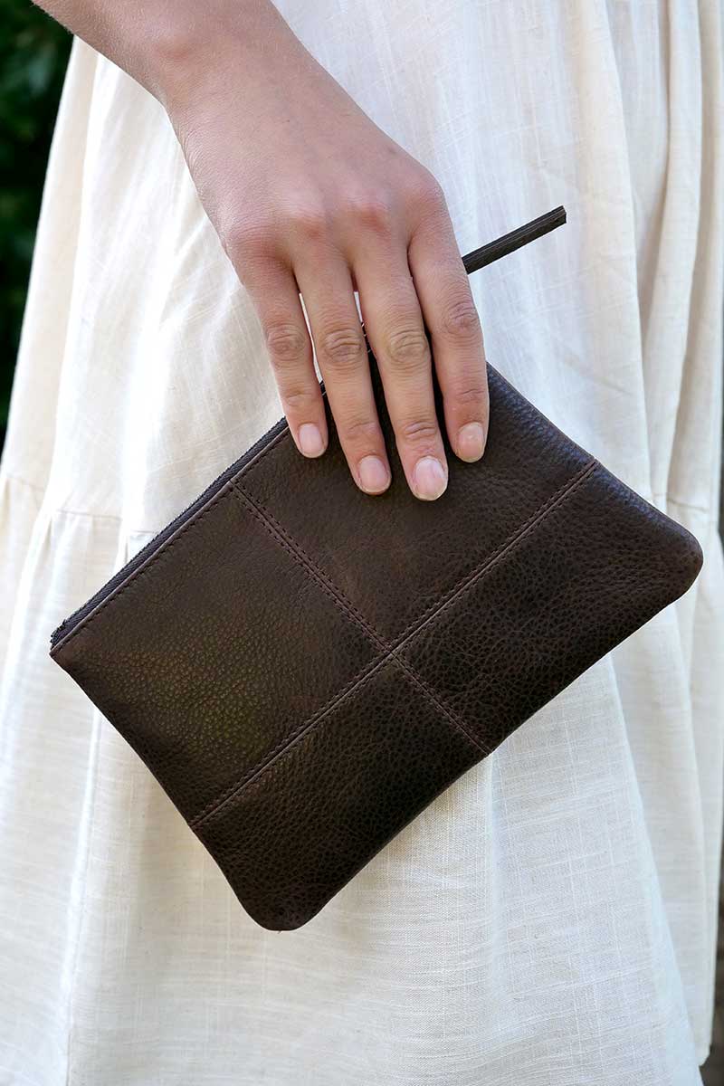 model holding Rugged Hide Leather Clutch - Mia Brown