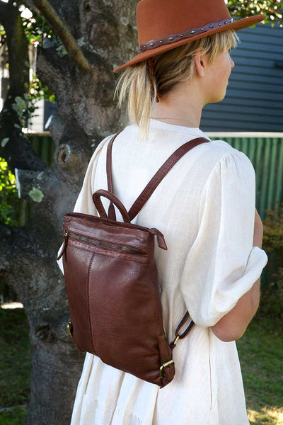 model wearing Rugged Hide Bag Pluto Backpack in Brandy