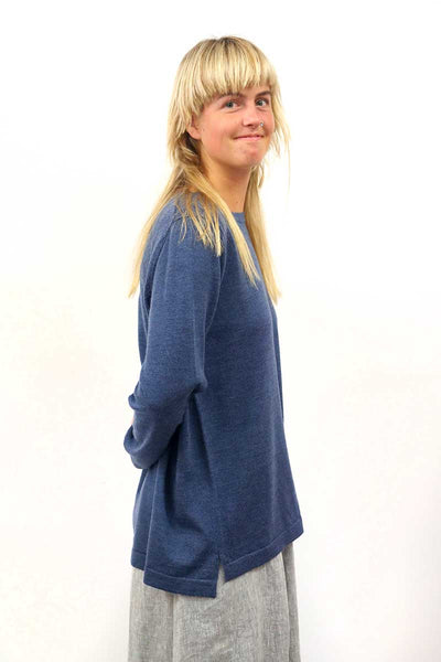 See side view of the Saw Denim Merino Round Neck Sweater